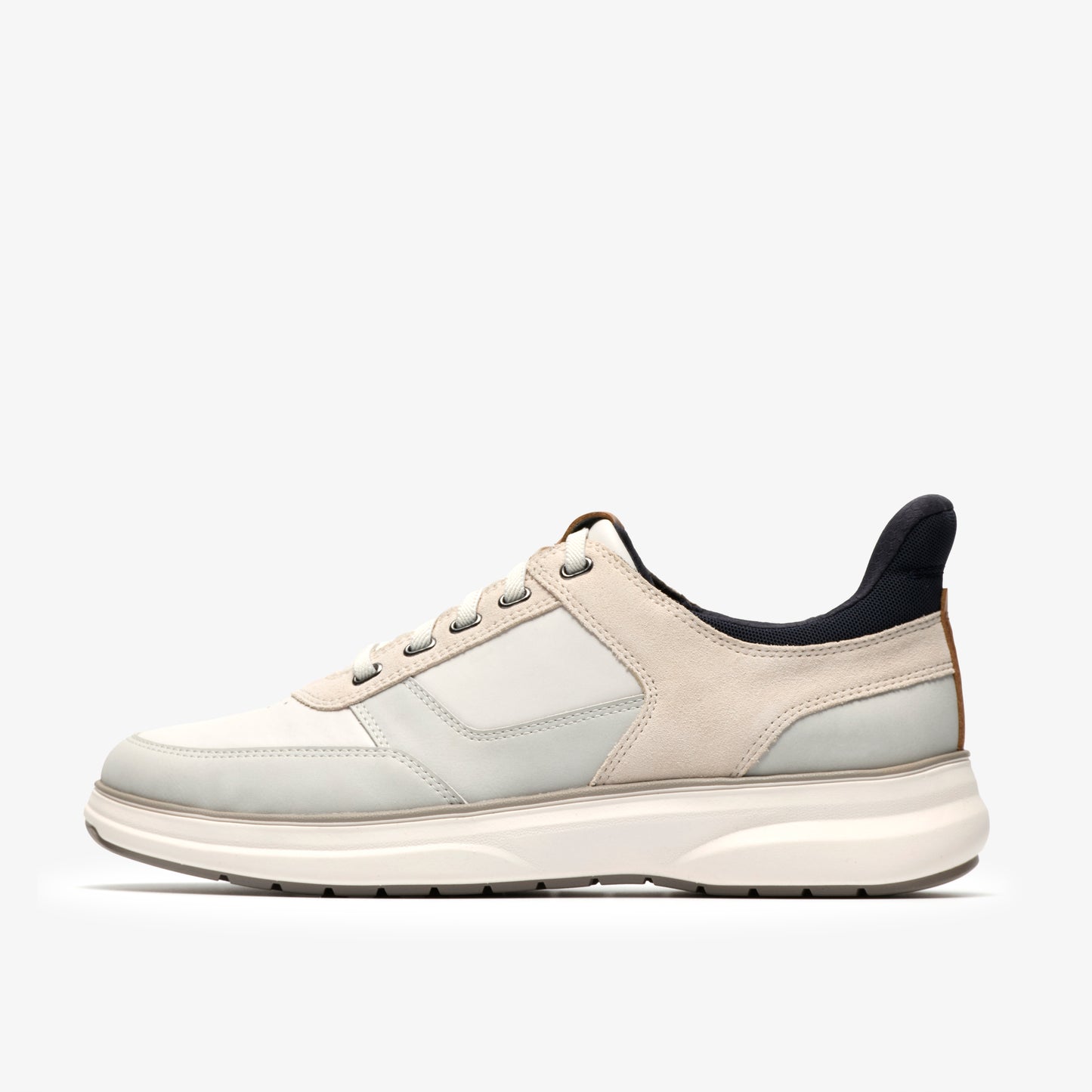 A low-rise athletic shoe with white and beige panels, and a gray sole.
