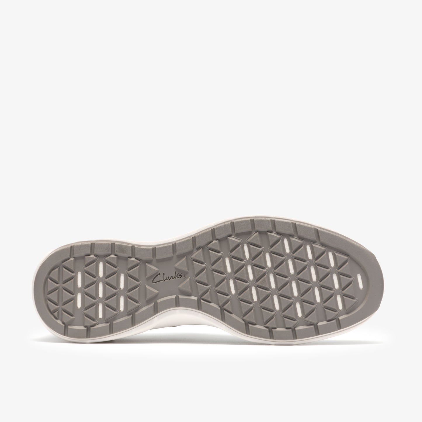 Angled view of a gray sneaker sole with triangular cuts.