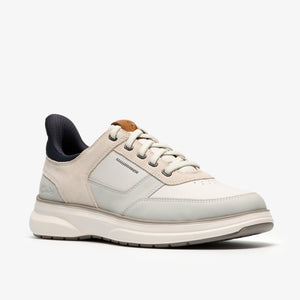 Low top sneaker with white and gray leather upper, white laces and sole, and black lining.