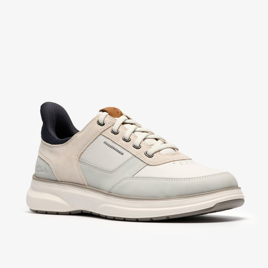 Low top sneaker with white and gray leather upper, white laces and sole, and black lining.