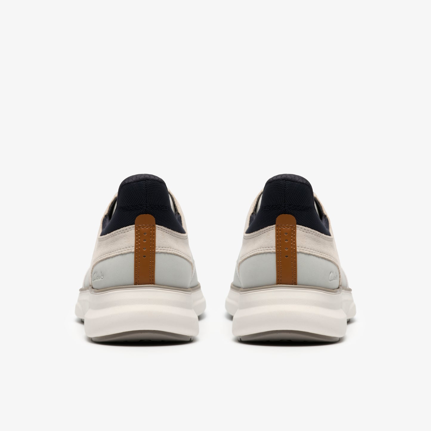 Pair of sneakers, rear view, with white and tan upper and thick white sole.