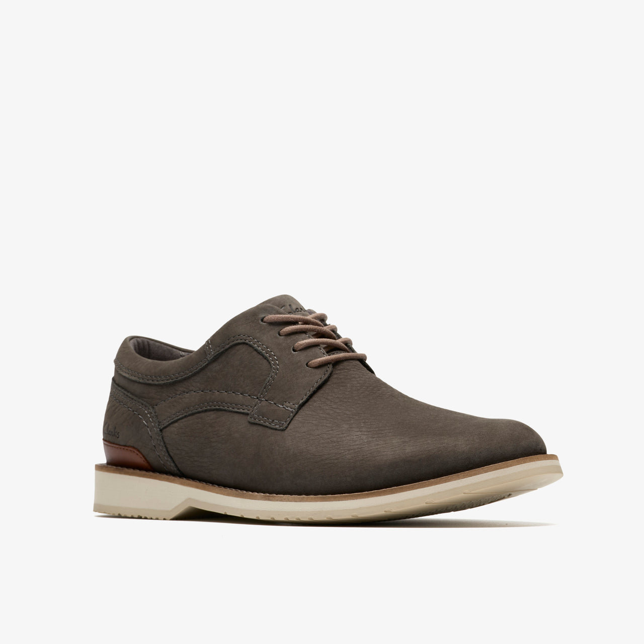 A grey leather dress shoe with a lace-up closure and a white sole.