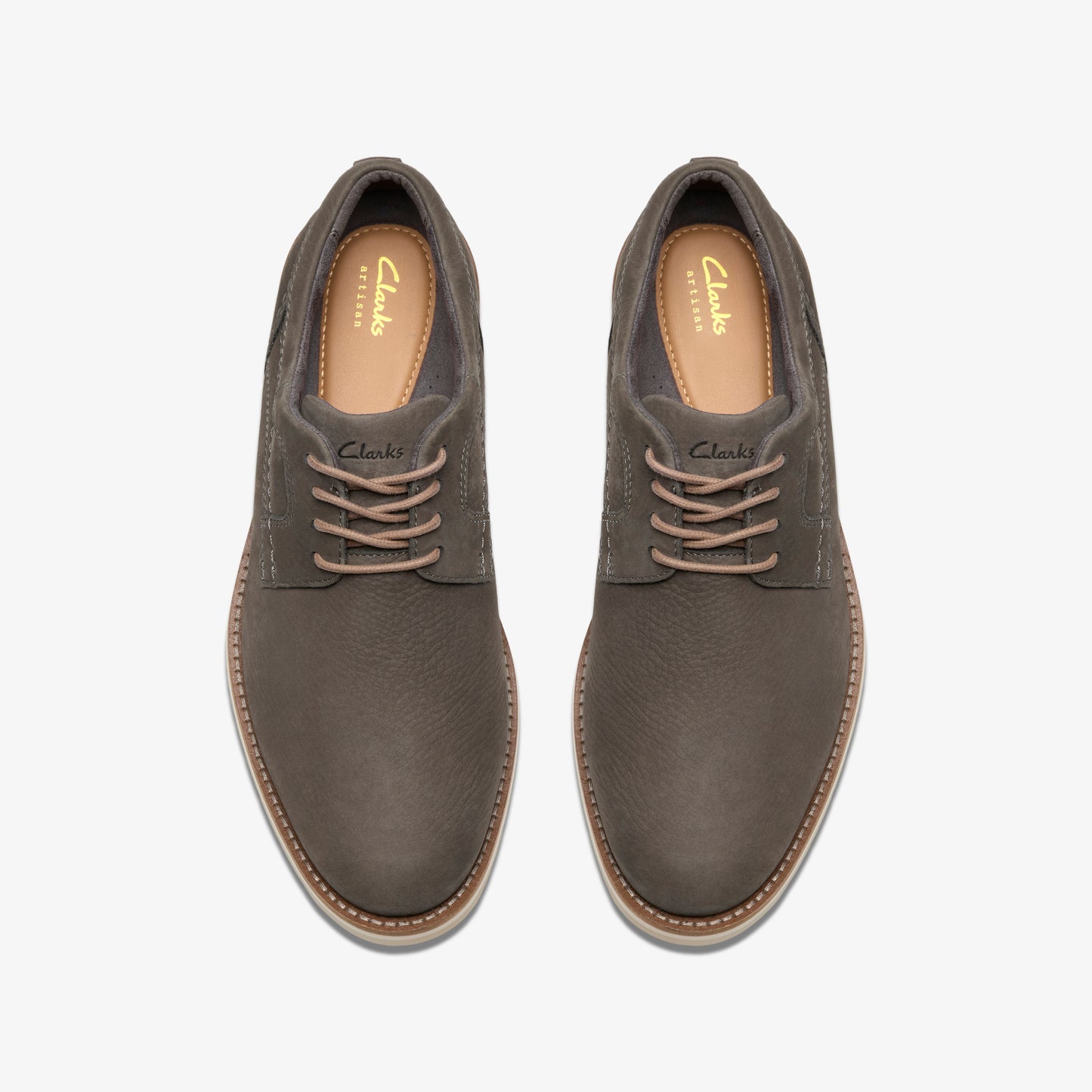 Top-down view of gray leather dress shoes with matching laces, visible insole text "Clarks ARTISAN".
