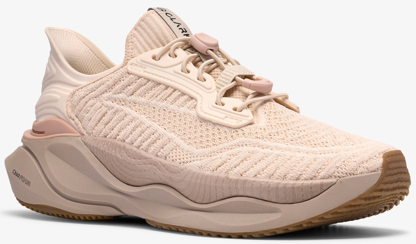 Beige colored running shoe with elastic cord laces and sculpted midsole.