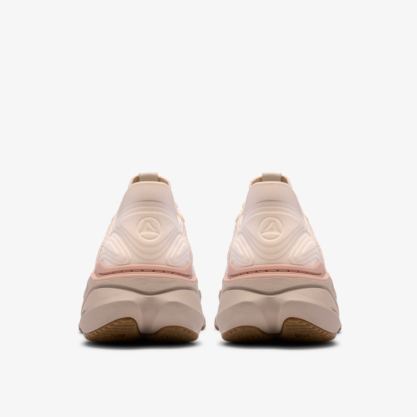 Rear view of two light-colored athletic shoes with round heel design.