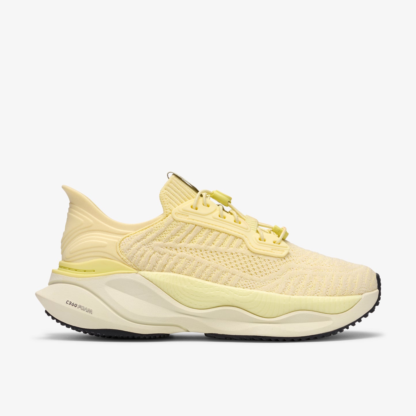 Light yellow running shoe with yellow laces and a chunky sole.