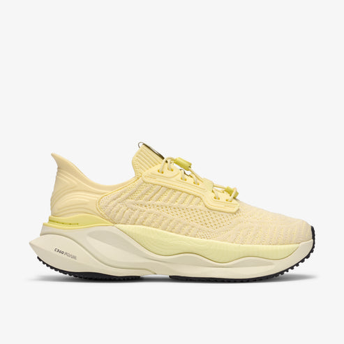 Light yellow running shoe with yellow laces and a chunky sole.