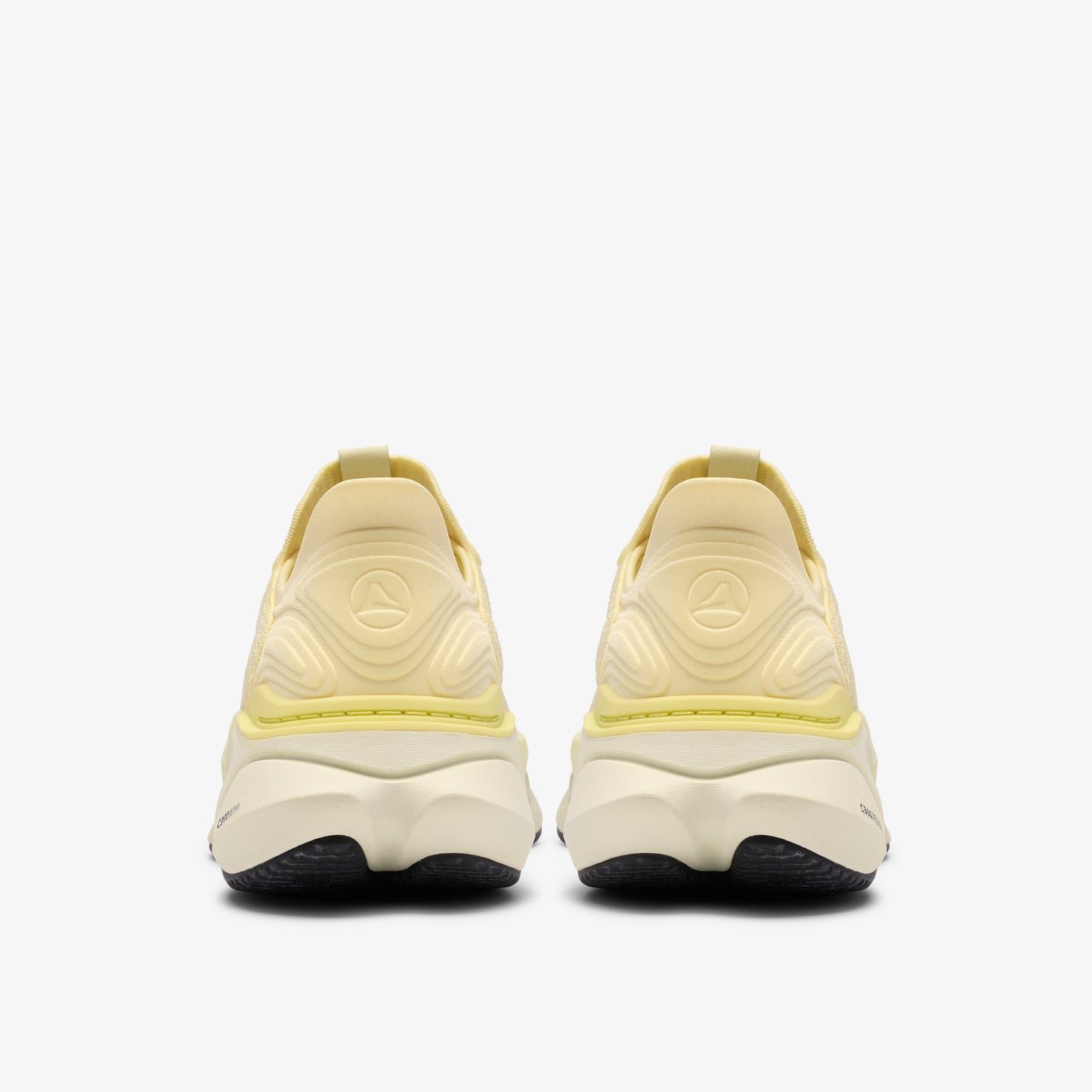 Rear view of two yellow running shoes with thick white soles and black outsoles.