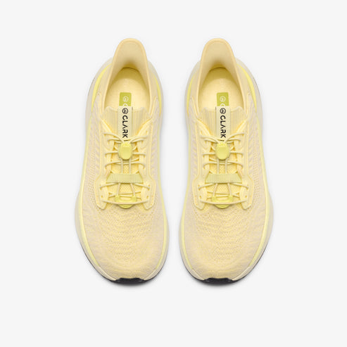 Pair of light yellow running shoes, seen from above, with visible lacing system and "CLARK" text on the tongue.