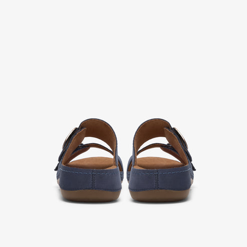 Pair of blue sandal shoes with brown insoles seen from behind.