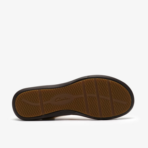 Shoe sole with a black border and tan grooved pattern, and logo 'Clarks' in the center.