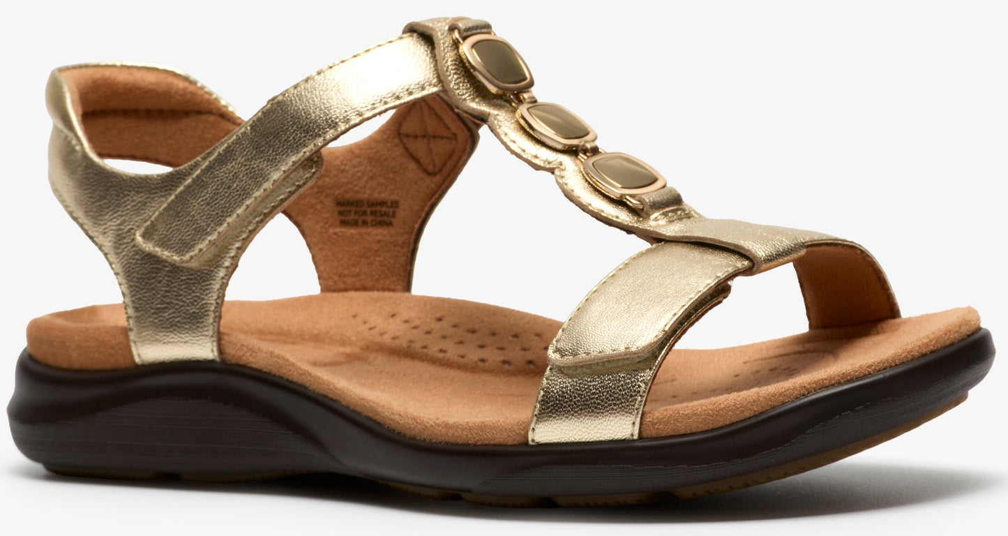 Gold sandal with decorative embellishments and velcro strap.