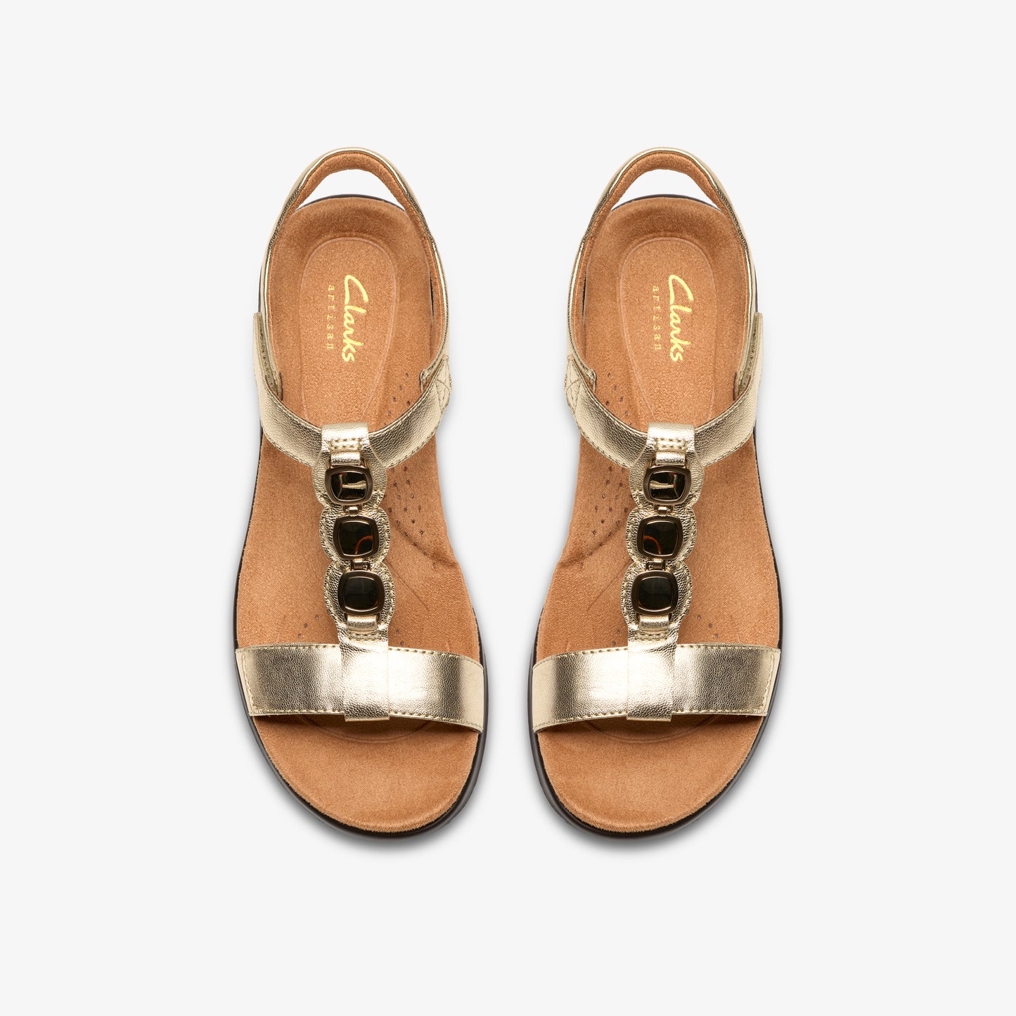 Pair of gold t-strap sandals with dark jewels.
