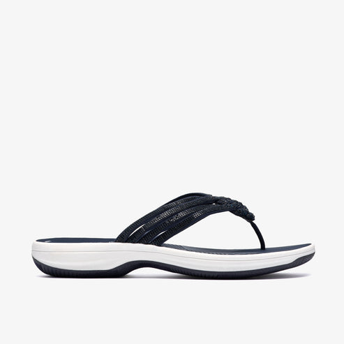 Navy sandal with braided straps and a white sole.