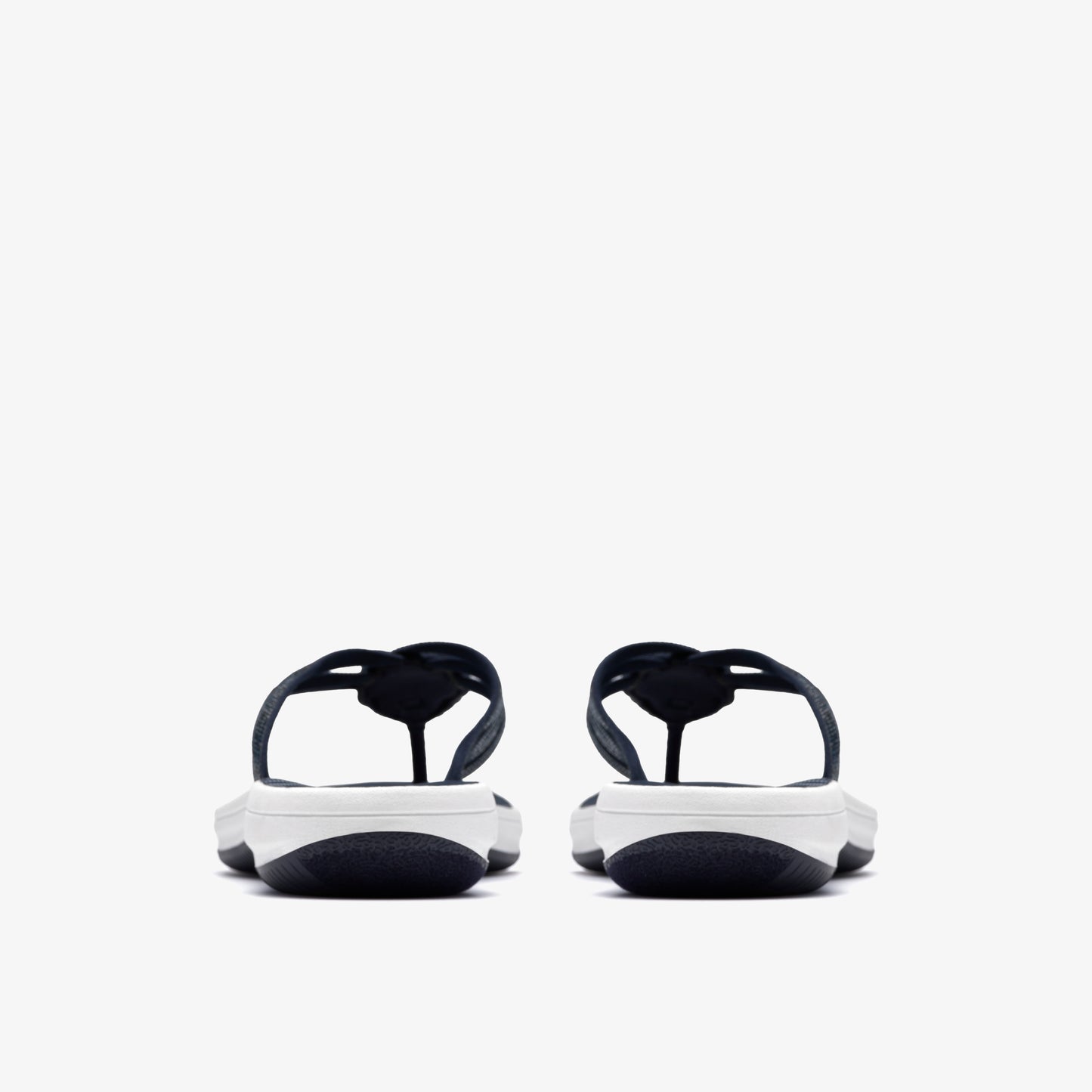 Pair of black and white flip-flops, rear view.