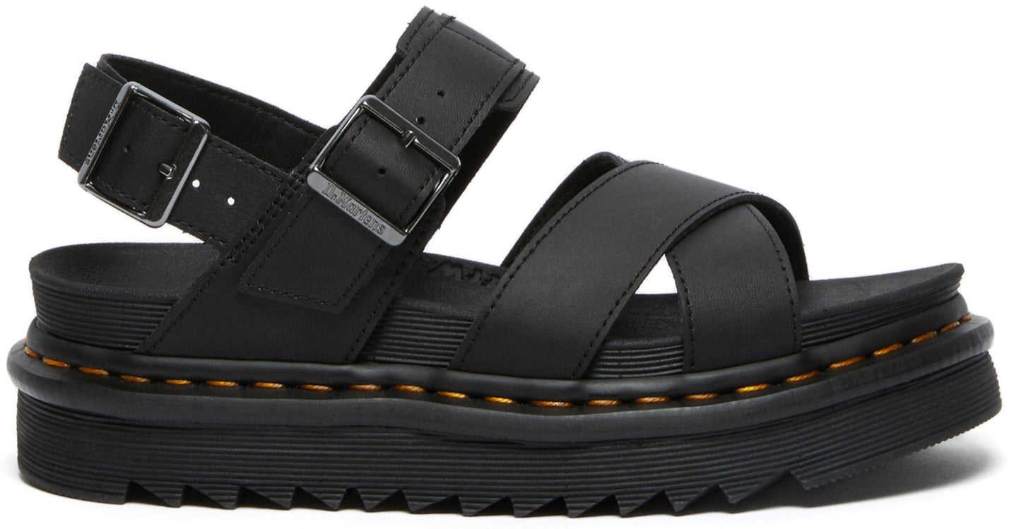Black sandal with adjustable buckle straps and a thick, ridged sole.