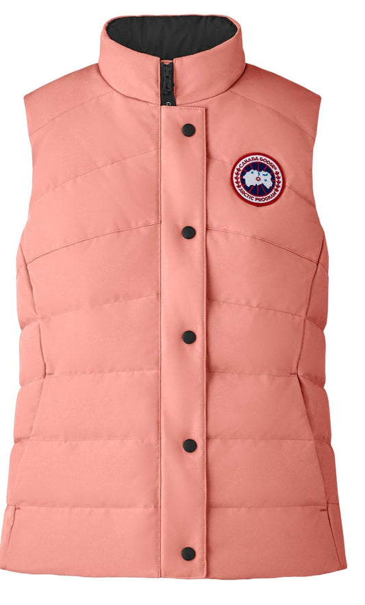 A pink quilted vest with black buttons, a black collar, and a circular logo on the chest.