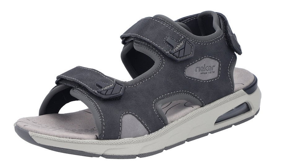 A gray sandal with velcro straps and the text "rieker since 1874" visible on the side.