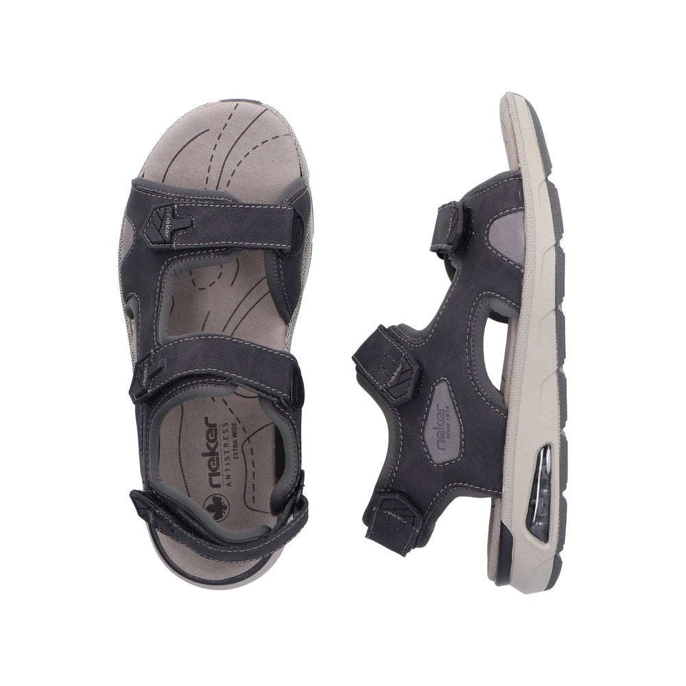 Pair of adjustable dark gray sandals with hook and loop straps and a light gray footbed.