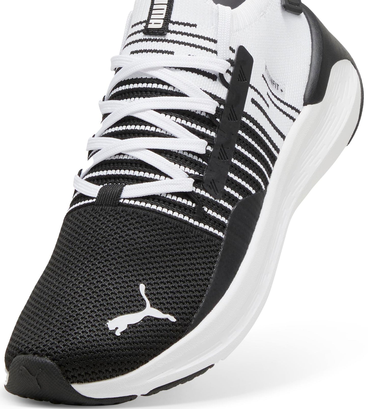 Close-up of a black and white athletic shoe with white laces and the Puma logo on the toe.