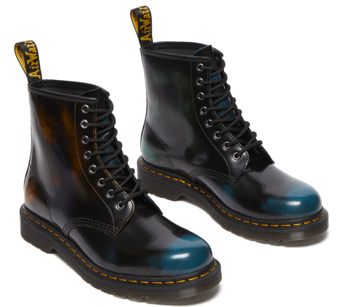 Pair of black boots with iridescent blue toe, lace up, with yellow tag on the ankle cuff