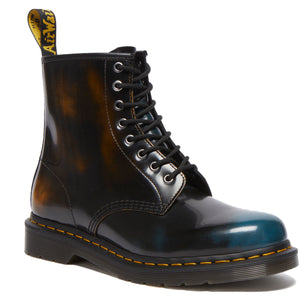 A glossy black ankle boot with yellow and turquoise accents and a yellow pull loop.