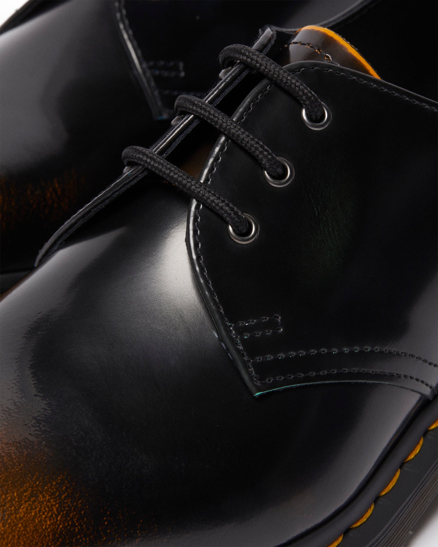 Close-up of a black, shiny leather dress shoe with black laces.