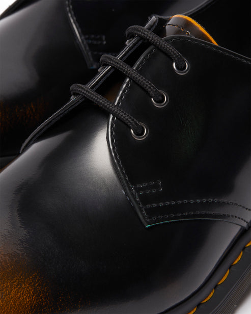Close-up of a black, shiny leather dress shoe with black laces.
