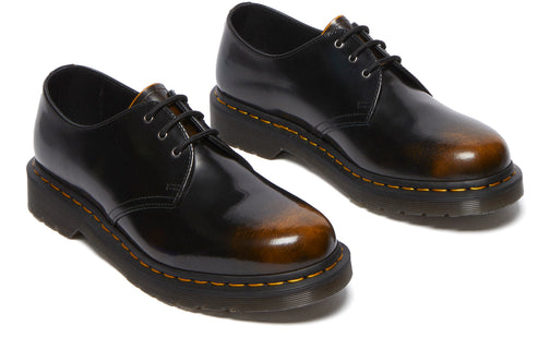 Pair of shiny black leather oxfords with brown toe, and black laces.