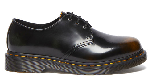 Black leather dress shoe with cap toe and yellow stitching.