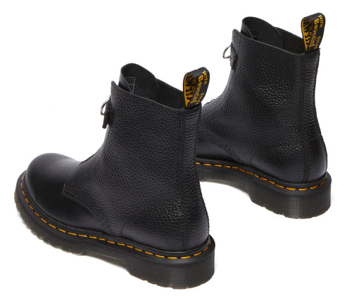 Two textured black leather ankle boots with yellow stitching on black soles, back view, pull tabs