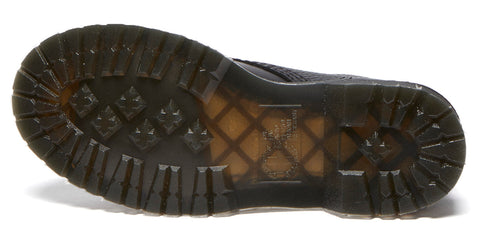 Close up of the outsole of a black shoe with a dark yellow grid pattern under translucent material.