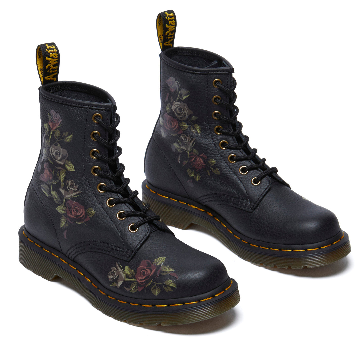 Pair of black ankle boots with rose floral print and yellow stitching.