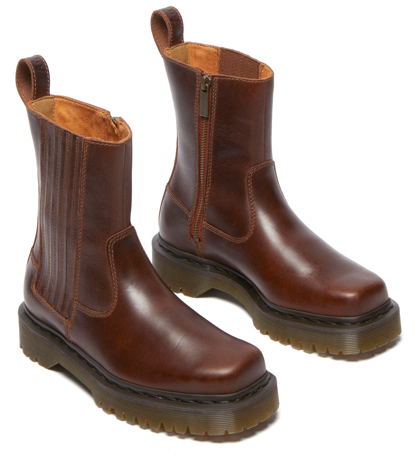 Pair of brown, leather, platform Chelsea boots with side zipper.