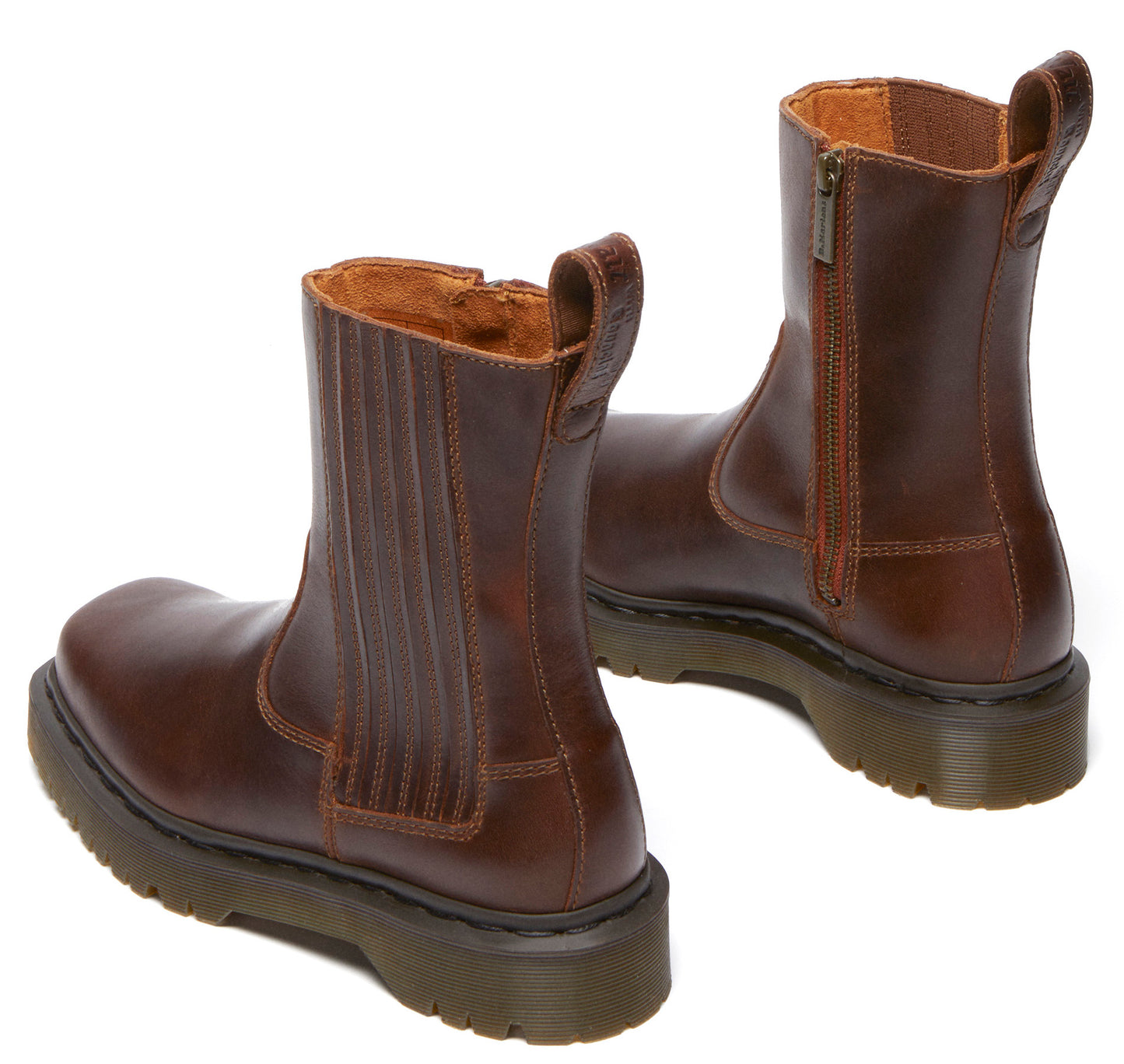 Pair of brown leather ankle boots with zippers and a thick sole.