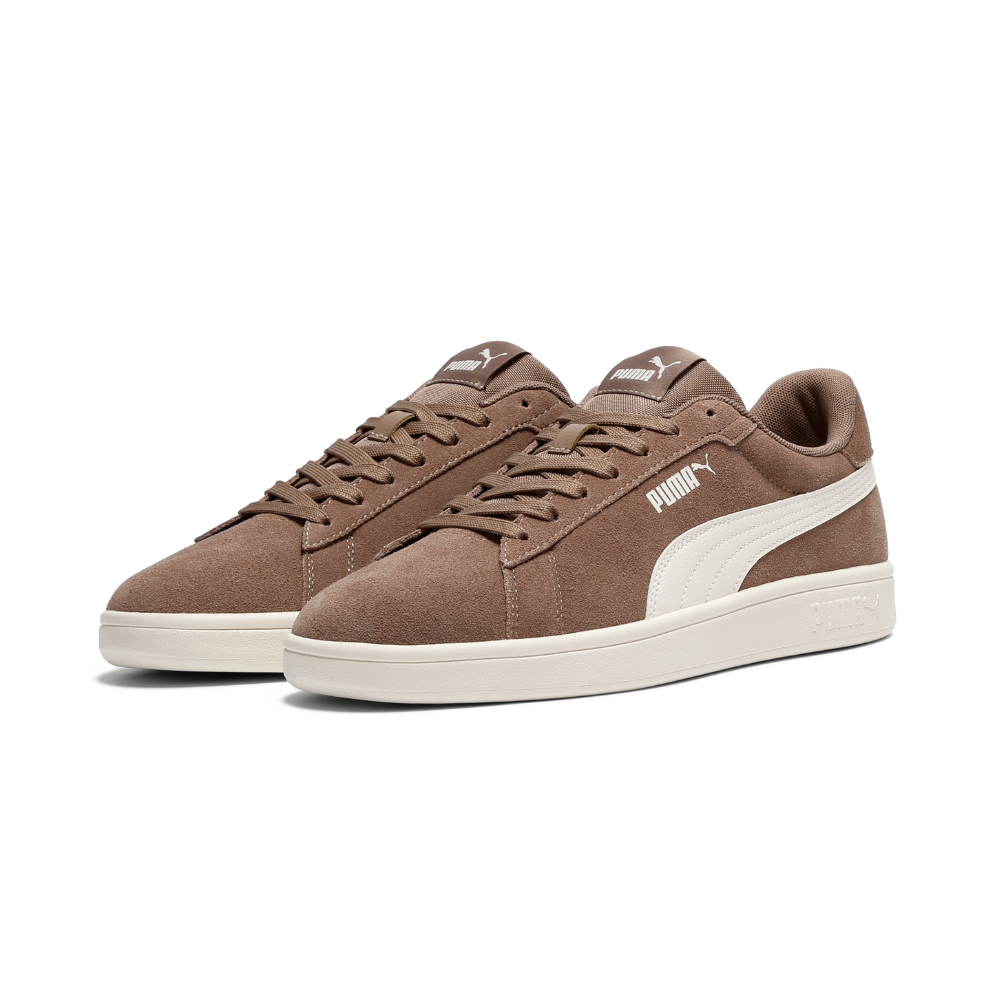 Pair of brown suede sneakers with white swoosh and laces.
