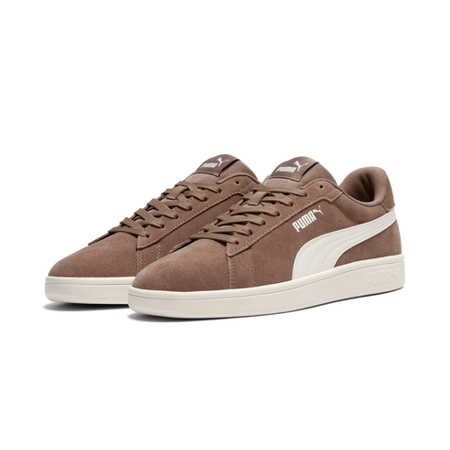 Pair of brown suede sneakers with white swoosh and laces.
