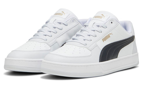 Pair of white sneakers with a black stripe and gold-colored logo on the side.