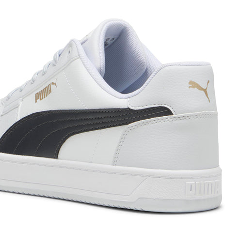 A white sneaker with a black stripe and gold lettering.