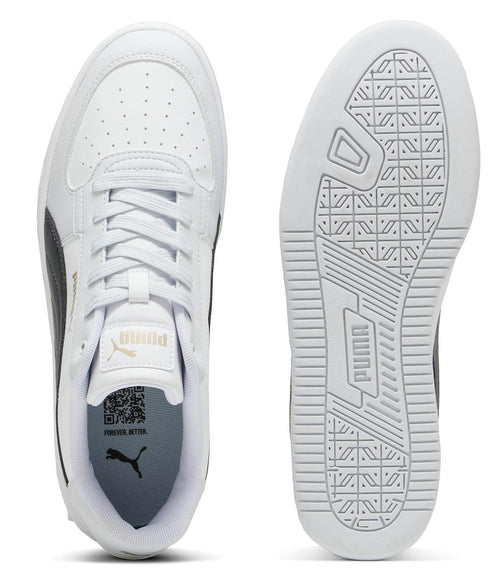 White sneakers with black and gold detail seen from above and from the sole.