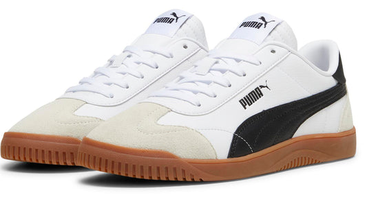 A pair of white low-top sneakers with a black logo stripe and a brown rubber sole. The toe cap is suede.