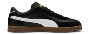 A black sneaker with a white stripe and a brown sole.
