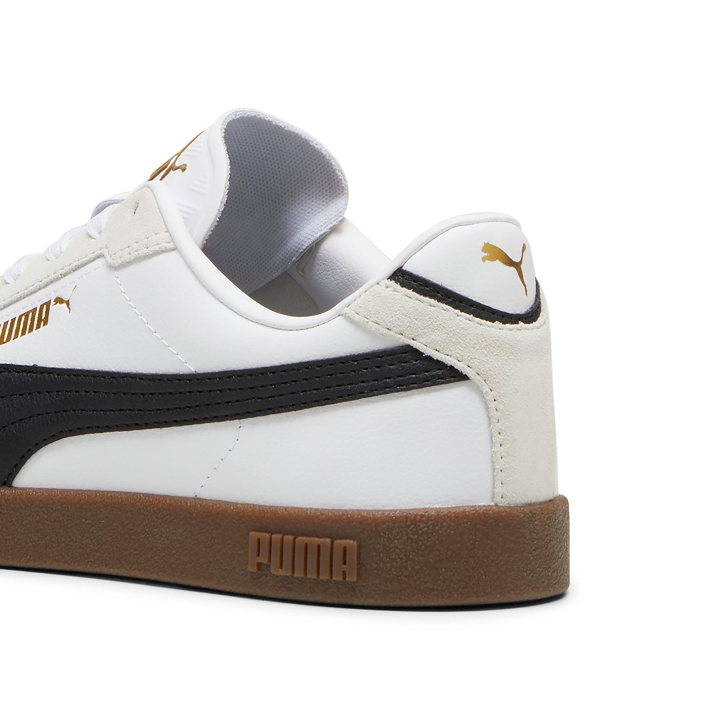 Close up of a white sneaker with a brown sole and a black side stripe.