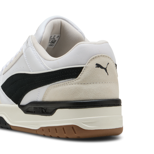White low-top sneaker with black stripe and logo near the heel.