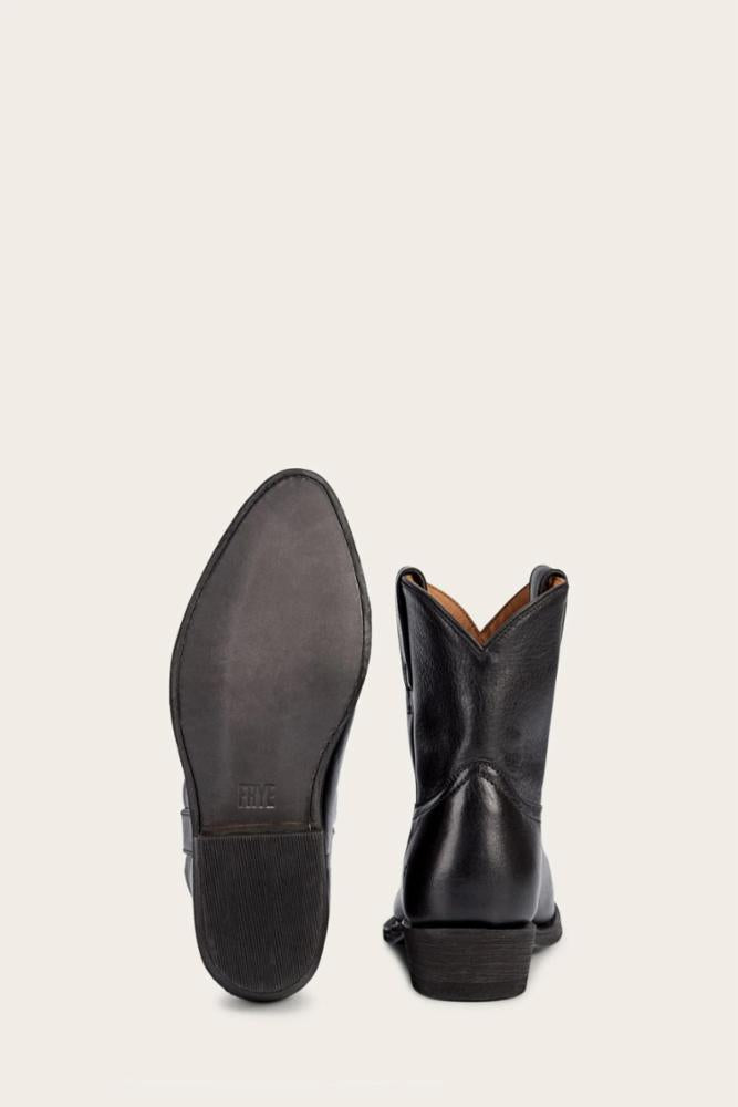 Pair of black leather cowboy boots with one sole visible.