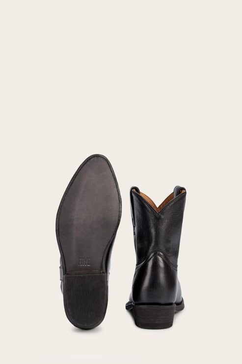 Pair of black leather cowboy boots with one sole visible.