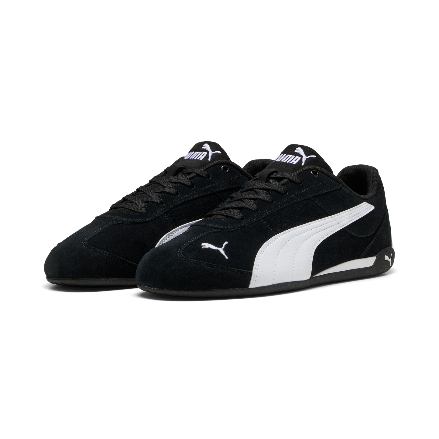 A pair of black suede low-top sneakers with a white logo and white stripe on the side.