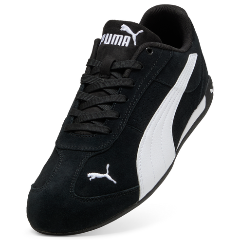 Low-profile black suede sneaker with white curved stripe and puma logo in white on tongue and toe.