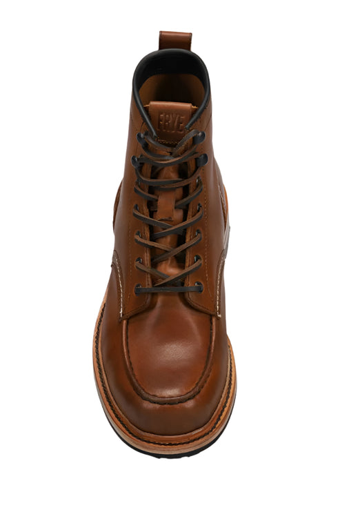 Front view of brown leather ankle boot with dark laces and dark trim.
