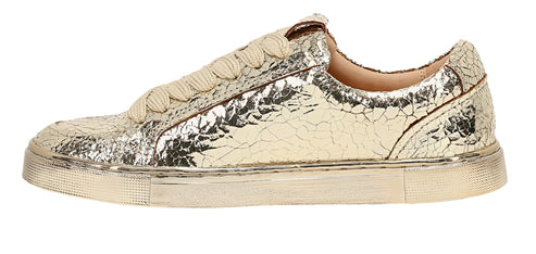 Gold slip-on sneaker with a textured surface.